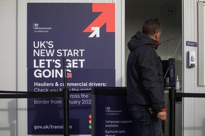 A pedestrian passes a portable government advice centre for lorry drivers and hauliers in Ipswich, U.K., on Monday, Dec. 28, 2020. The trade agreement between the U.K. and the European Union brought welcome relief to businesses, averting the prospect of punitive tariffs and a chaotic no-deal split from Britain's largest trading partner this week. Photographer: Chris Ratcliffe/Bloomberg