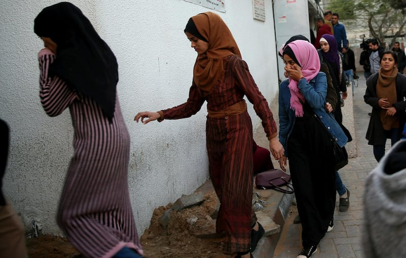 Relatives arrive to the morgue of Shifa hospital to see the body of a woman was killed by Israeli troops during a protest at the Gaza Strip's border with Israel, in Gaza City. Spokesman Ashraf al-Kidra says the woman was shot in the head Friday at a protest site east of Gaza City. AP