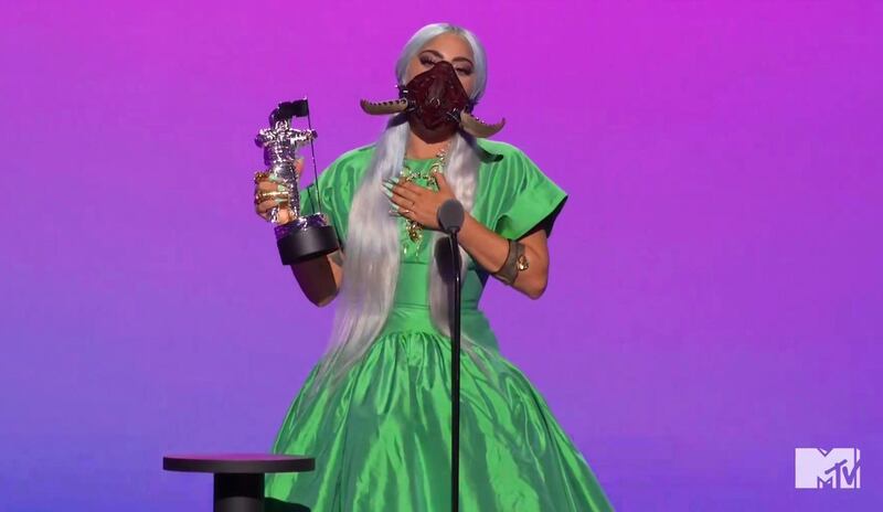 Lady Gaga, in a Christoper John Rogers gown and Lance V Moore mask, accepts the award for Song of the Year during the MTV Video Music Awards. AP
