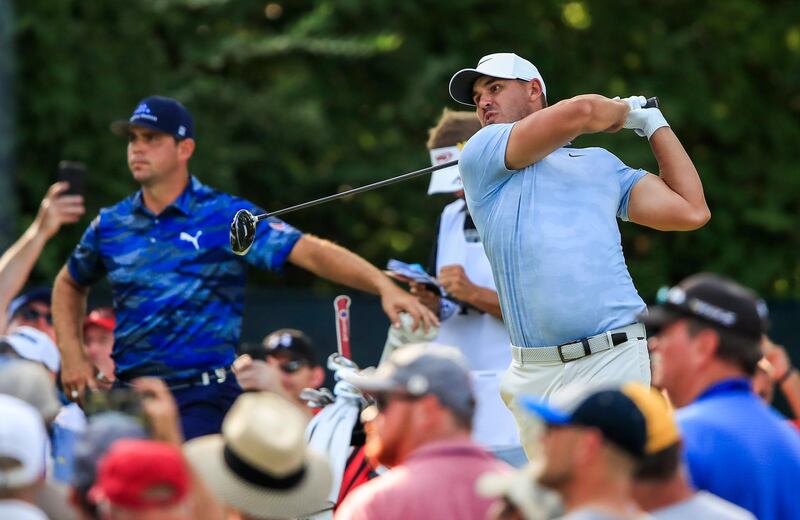 epa06944768 Gary Woodland of the US (L) watches as Brooks Koepka of the US hits his tee shot on the fifteenth hole during the third round of the 100th PGA Championship golf tournament at Bellerive Country Club in St. Louis, Missouri, USA, 11 August 2018.  EPA/TANNEN MAURY
