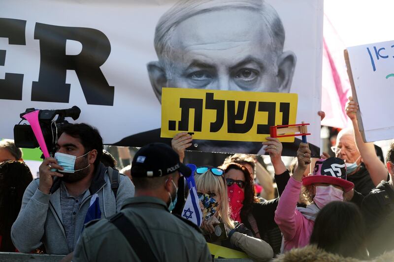 Protesters hold banners and placards as they demonstrate against Israeli Prime Minister Benjamin Netanyahu as he attends a hearing in his corruption trial in Jerusalem. The Hebrew word on the placard reads, " You failed". Reuters