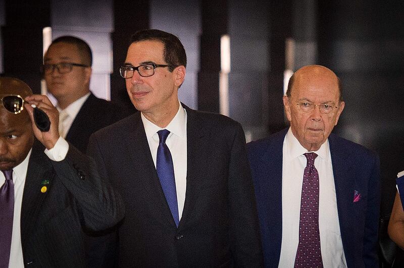 US Treasury Secretary Steven Mnuchin (L) and US Commerce Secretary Wilbur Ross (R) walk through a hotel lobby as they head to the Diaoyutai State Guest House to meet Chinese officials for ongoing trade talks in Beijing on May 4, 2018.
Top US and Chinese officials kicked off crucial trade talks on May 3 in Beijing but both sides sought to dampen expectations for a quick resolution to a heated dispute between the world's two largest economies. / AFP PHOTO / NICOLAS ASFOURI