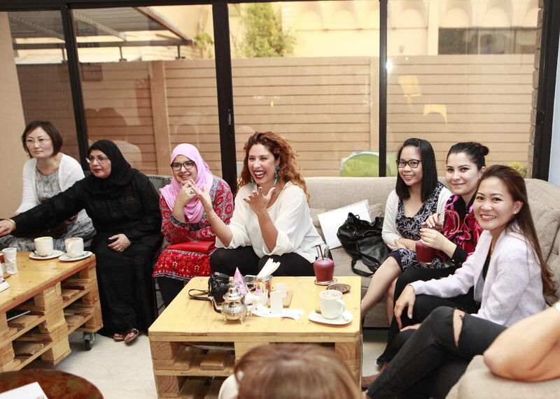 A meeting of the Gutsy Women Circle at The Third Place Cafe in Khalidiya. Abu Dhabi. Chérine Kurdi, pictured centre in the white blouse, is the founder of the group. Sarah Dea / The National