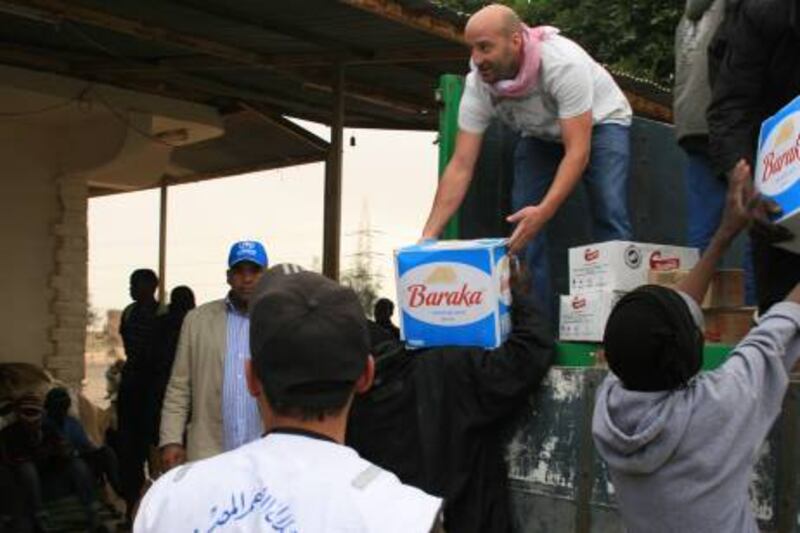 "Mubarak Abdullatif offloads food supplies at Salloum, on the border of Libya and Egypt".  Courtesy Mubarak Abdullatif