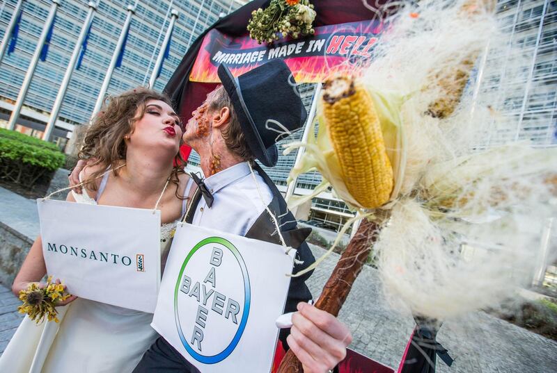 epa06618055 (FILE) - A woman and a man dressed as bride and groom pose during an action 'marriage made in hell' to denounce the threat posed by the planned merger of Bayer and Monsanto in front of the EU Commission building in Brussels, Belgium, 30 March 2017 (reissued 21 March 2018). The European Commission on 21 March 2018 approved the acquisition of Monsanto by Bayer under the EU Merger Regulation. German conglomerate Bayer can now proceed with its 62.5 billion US dollars buy of US agrochemical and agricultural biotechnology corporation Monsanto.  EPA/STEPHANIE LECOCQ *** Local Caption *** 53424987