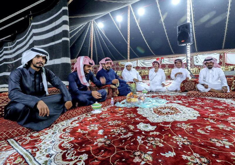 Abu Dhabi, United Arab Emirates, December 10, 2019.  
  --Men of the Dawasr tribe from Saudi Arabia relax after a victory at the Al Dhafra Festival in Abu Dhabi, UAE.
Victor Besa/The National
Section:  NA
Reporter:  Anna Zacharias