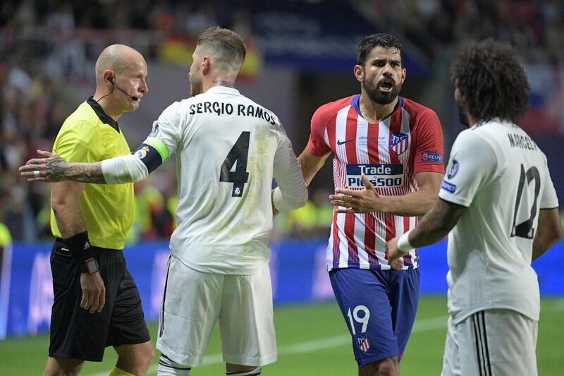 Ramos remonstrates with Polish referee Szymon Marciniak, left, as Marcelo and Costa look on. AFP