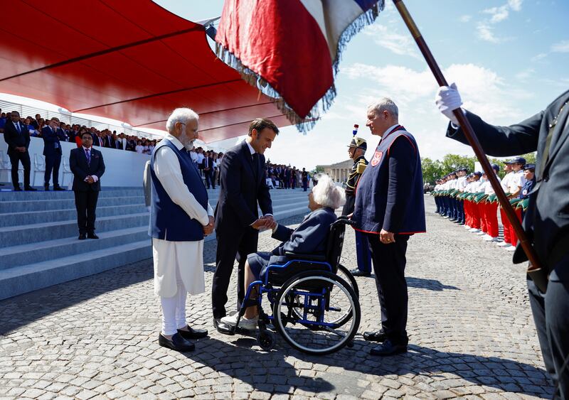 Mr Modi and Mr Macron meet Second World War veteran Odile de Vasselot during the annual Bastille Day parade in Paris. EPA 