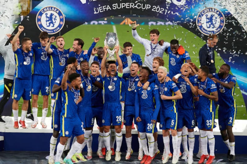 Chelsea players lift the trophy.