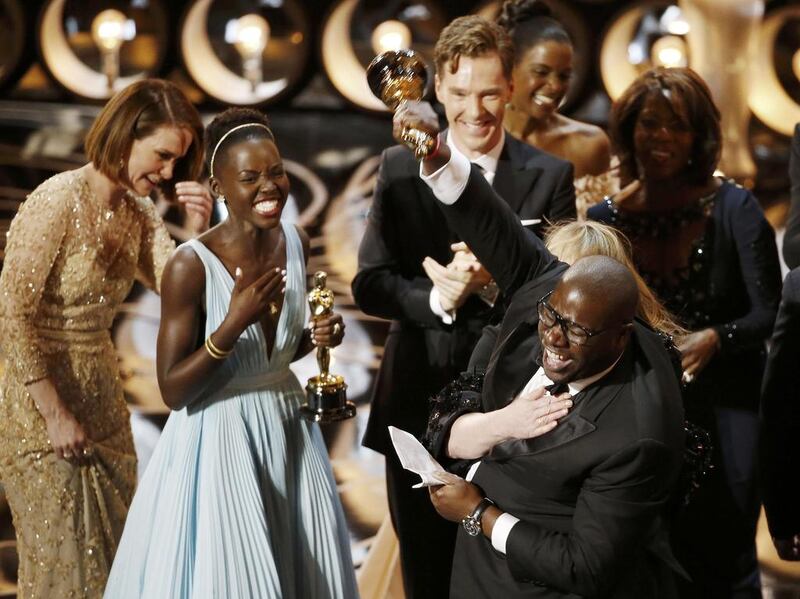 Director and producer Steve McQueen celebrates after accepting the Oscar for best picture with Lupita Nyong'o. Reuters