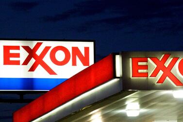 Exxon signs at a petrol station in Manassas, Virginia. Exxon is cutting 1,90 jobs in the US as part of a broader plan to shed 14,000 staff over the next two years, AFP