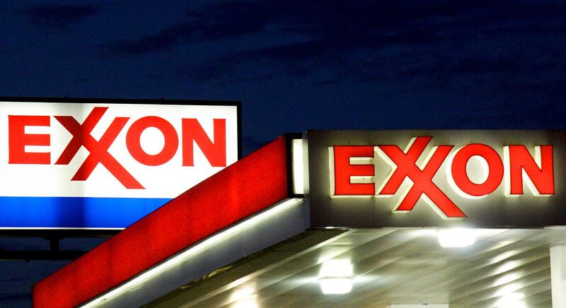(FILES) In this file photo taken on September 20, 2008, Exxon signs at a station in Manassas, Virginia. Exxon Mobil said on October 29, 2020, it was eliminating 1,900 US jobs as part of a cost-cutting drive necessitated in part by the hit the Covid-19 pandemic inflicted on oil prices. / AFP / KAREN BLEIER
