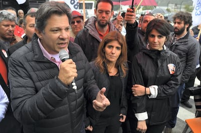 Brazilian vice-presidential candidate for the Worker's Party (PT) Fernando Haddad (L), speaks at the entrance of the Volkswagen plant next to Manuela D'Avila (R), of Brazil's Communist Party (PCdoB), in Sao Bernardo do Campo, some 25 km from Sao Paulo, Brazil, on September 5, 2018, ahead of the October 7 national election.
Leftist ex-president Luiz Inacio Lula da Silva will appeal his barring from October's elections to the United Nations and Brazil's Supreme Court, Haddad -the man set to replace him on the ballot- said eralier this week. / AFP PHOTO / NELSON ALMEIDA