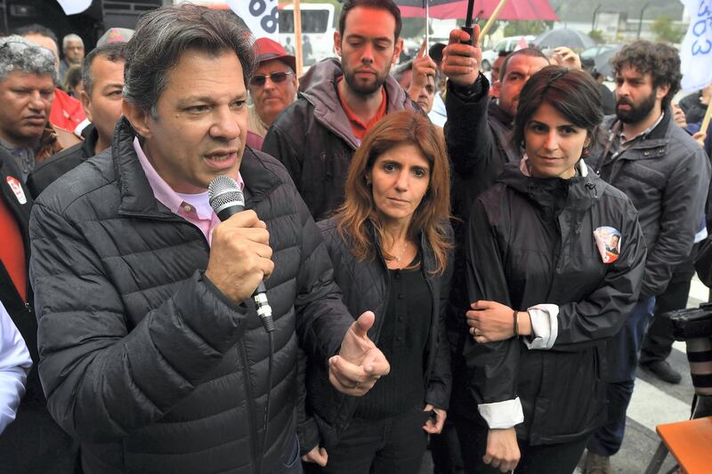 Brazilian vice-presidential candidate for the Worker's Party (PT) Fernando Haddad (L), speaks at the entrance of the Volkswagen plant next to Manuela D'Avila (R), of Brazil's Communist Party (PCdoB), in Sao Bernardo do Campo, some 25 km from Sao Paulo, Brazil, on September 5, 2018, ahead of the October 7 national election.
Leftist ex-president Luiz Inacio Lula da Silva will appeal his barring from October's elections to the United Nations and Brazil's Supreme Court, Haddad -the man set to replace him on the ballot- said eralier this week. / AFP PHOTO / NELSON ALMEIDA