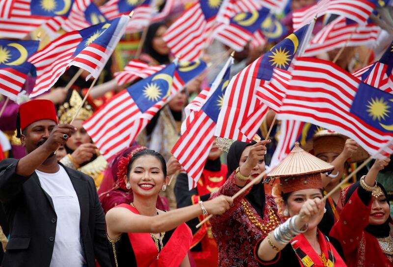 Performers with Malaysia flags celebrate National Day at Putrajaya last month. Malaysia's is a cosmopolitan society. Reuters