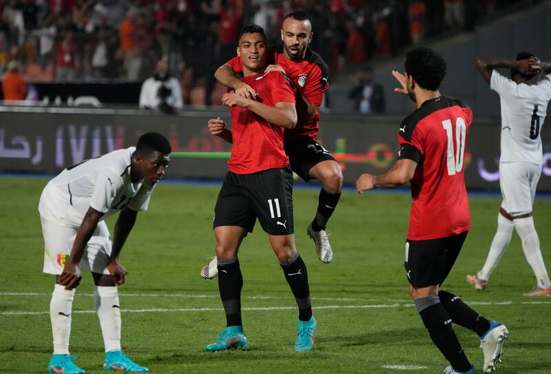 Egypt's players celebrate after scoring their goal against Guinea during their soccer match in Group D 2023 Cup of Nations (AFCON) qualifiers at Cairo International stadium in Cairo, Egypt.  Egypt won 1-0. AP Photo