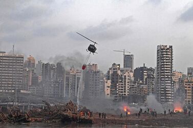 A helicopter tries to put out multiple fires at the scene of the massive explosion that hit Beirut's port on Tuesday. AFP