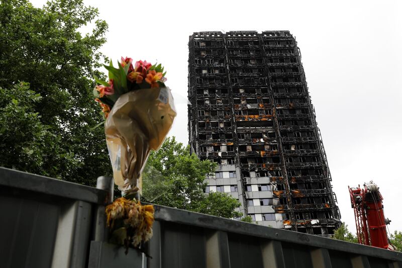 A floral tribute is seen near the Grenfell Tower, which was destdroyed in a fatal fire, in London, Britain July 15, 2017.  REUTERS/Tolga Akmen