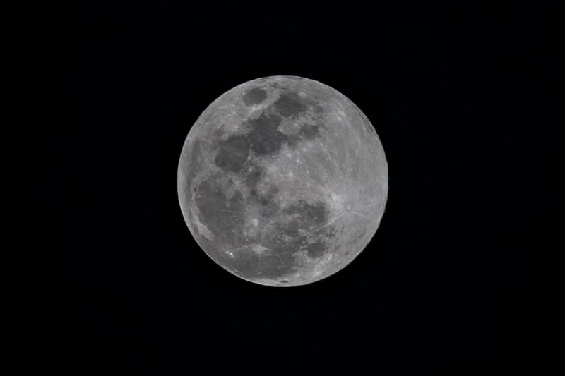 Pictured over Caracas, Venezuela, the Cold Moon has a higher trajectory than most full moons. AFP 