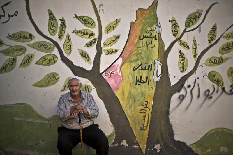 Palestinian refugee Ali Abu Jabal, 73, in front of a wall painted with a mural depicting the holy land, in the West Bank refugee camp of Jenin. The man was 7 years old when he and his parents were forced to leave their home in the Israeli city of Haifa during what the Palestinians call the “Nakba,” or “catastrophe” referring to their uprooting in the war over Israel’s 1948 creation. 