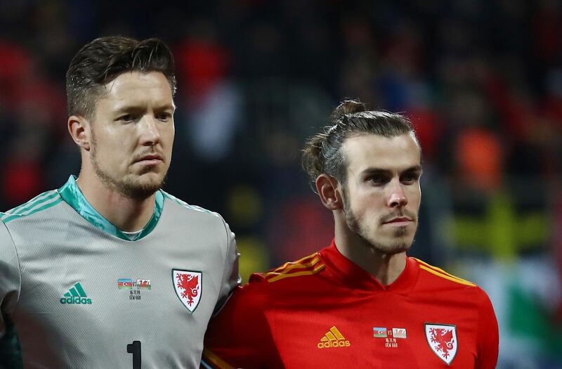 Wales's Wayne Hennessey and Gareth Bale line up before the match. Reuters