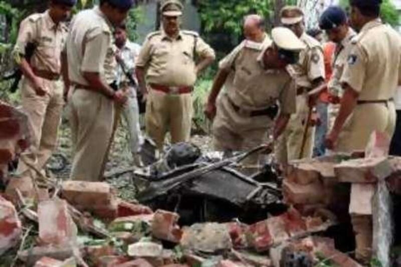 Indian security personnel search for evidence near a bomb blast site in the western Indian city of Ahmedabad July 27, 2008. India's major cities were put on high alert on Sunday, with fears of more attacks after at least 46 people were killed in two days of bombings that hit Ahmedabad and Bangalore. REUTERS/Amit Dave (INDIA) *** Local Caption ***  DEL30_INDIA-BLASTS-_0727_11.JPG