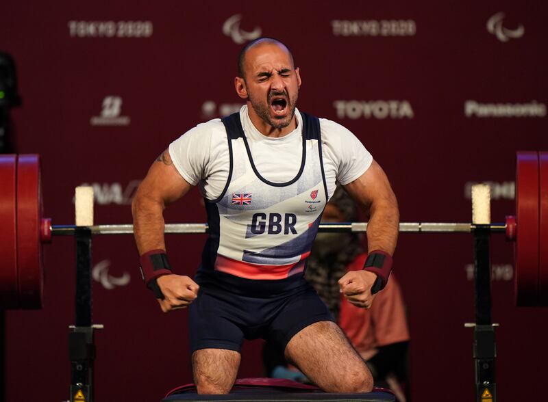 Ali Jawad celebrates after the second lift in the men's -59 kg final at the Tokyo International Forum during day three of the Tokyo 2020 Paralympic Games.