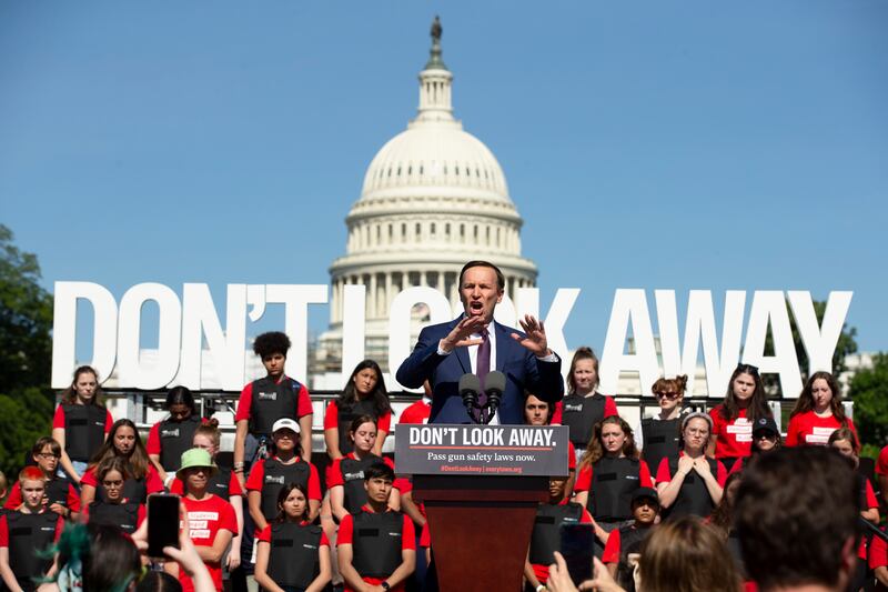 Democratic Senator from Connecticut Chris Murphy, speaks in front of young people wearing body armor and a sign that reads 'Don't Look Away', during a rally held by gun safety supporters and advocates demanding gun safety reforms, on the west front of the US Capitol, in Washington, DC, USA, 06 June 2022.  Continual mass shootings in the United States have advocates of gun safety reforms demanding action from lawmakers.   EPA / MICHAEL REYNOLDS