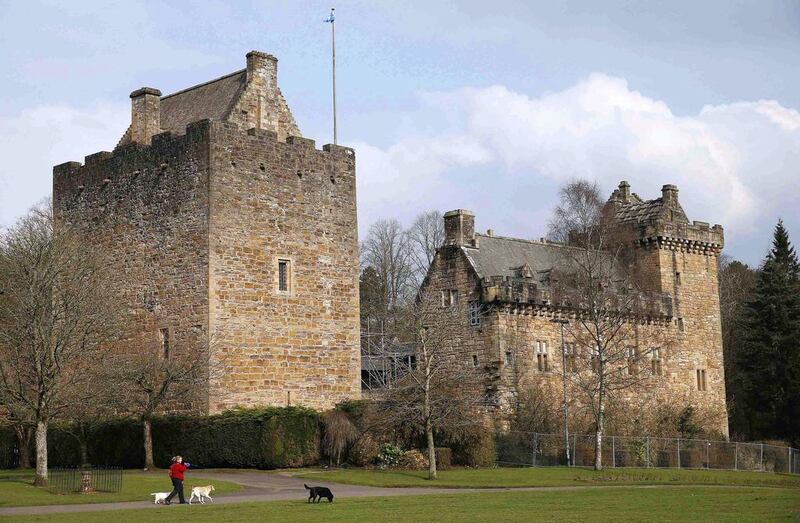 A woman walks her dogs outside Dean Castle in Kilmarnock. Suzanne Plunkett / Reuters