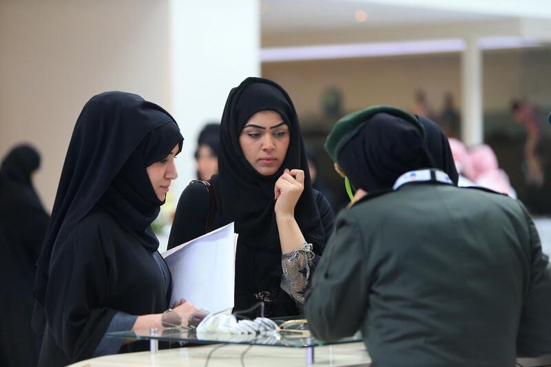 Jobseekers at the recruitment fair in Abu Dhabi yesterday are briefed on the careers available in the Armed Forces. Ravindranath K / The National