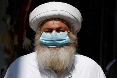 A man wears a protective face mask as he walks along the main market in downtown after the government eased the restrictions on movement aimed at containing the spread of the coronavirus, in Amman, Jordan April 29, 2020. REUTERS