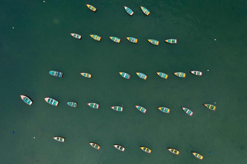 Row boats moored near a jetty.