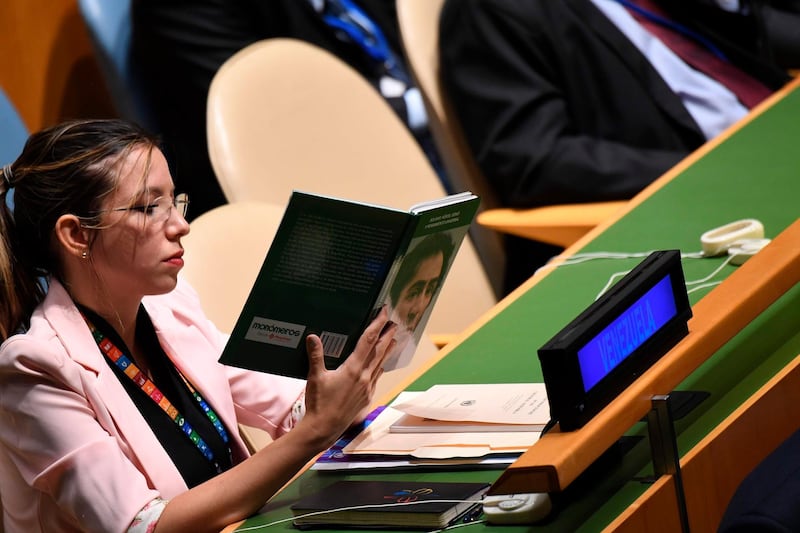 A delegate from Venezuela holds up a book referring to Simon Bolivar, a Venezuelan military and political leader, titled "Bolivar, Heroe, Genio y Pensamiento Universal" (Bolivar, hero, genius and universal thinker), during US President Donald Trump's address at the 74th Session of the United Nations General Assembly. AFP