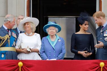 Prince Harry and Meghan Markle stand next to Queen Elizabeth II on the balcony of Buckingham Palace in 2018. AFP