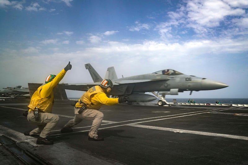 In this Thursday, May 16, 2019 photo released by the U.S. Navy, Lt. Nicholas Miller, from Spring, Texas, and Lt. Sean Ryan, from Gautier, Miss., launch an F-18 Super Hornet from the deck of the USS Abraham Lincoln aircraft carrier in the Arabian Sea. On Saturday, May 18, 2019, U.S. diplomats warned that commercial airliners flying over the wider Persian Gulf faced a risk of being "misidentified" amid heightened tensions between the U.S. and Iran. (Mass Communication Specialist 3rd Class Jeff Sherman, U.S. Navy via AP)