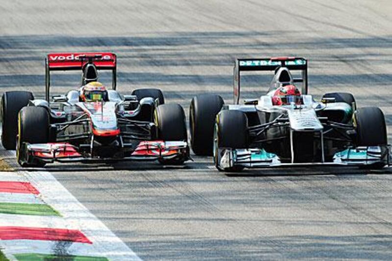 Every driver is allowed to move once but Michael Schumacher, right, weaved more than that to keep Lewis Hamilton at bay.