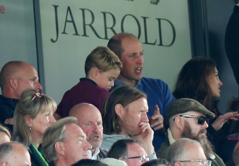 Prince William and Prince George in the stands during the match. Reuters