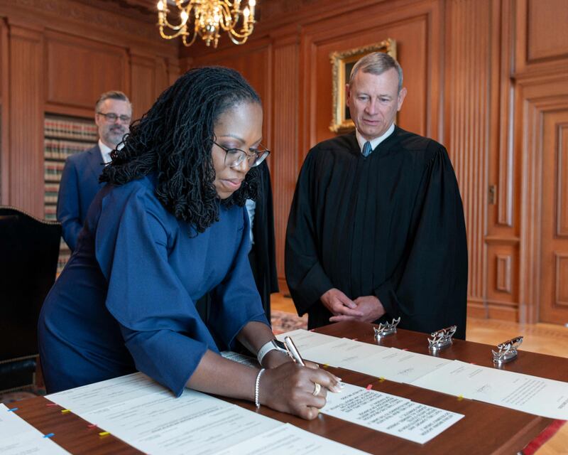 Justice Ketanji Brown Jackson signs the Oaths of Office in the Justices' Conference Room at the Supreme Court in Washington, DC, on June 30. The US made history this year as Ketanji Brown Jackson was sworn in as the first Black woman to serve on the Supreme Court. AFP