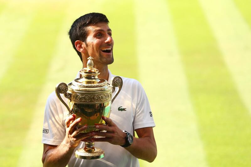 LONDON, ENGLAND - JULY 15:  Novak Djokovic of Serbia celebrates with the trophy after winning the Men's Singles final against Kevin Anderson of South Africa on day thirteen of the Wimbledon Lawn Tennis Championships at All England Lawn Tennis and Croquet Club on July 15, 2018 in London, England.  (Photo by Matthew Stockman/Getty Images) *** BESTPIX ***