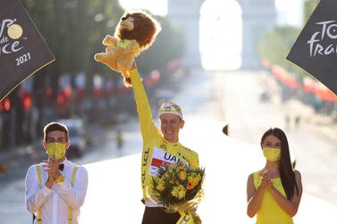 FILE PHOTO: Cycling - Tour de France - Stage 21 - Chatou to Paris Champs-Elysees - France - July 18, 2021 UAE Team Emirates rider Tadej Pogacar of Slovenia celebrates on the podium after winning the yellow jersey and the Tour de France Pool  via REUTERS / Garnier Etienne / File Photo