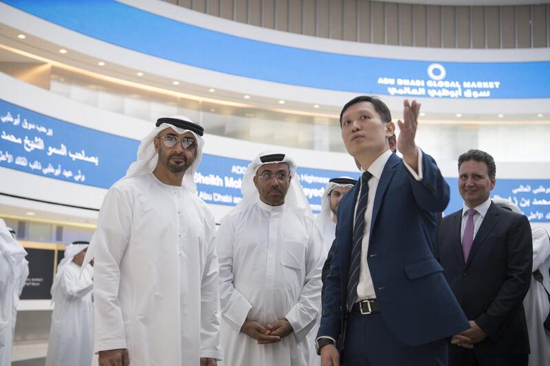 Sheikh Mohammed speaks with Richard Teng CEO of the Financial Services Regulatory Authority at Abu Dhabi Global Market, while visiting Abu Dhabi Global Market on Al Maryah Island with Ahmed Ali Al Sayegh, Chairman of Abu Dhabi Global Market, second left. Hamad Al Kaabi / Crown Prince Court - Abu Dhabi