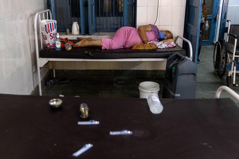 A woman receives treatment inside a COVID-19 ward of a government-run hospital, amidst the coronavirus disease pandemic, in Bijnor district, Uttar Pradesh, India. Reuters