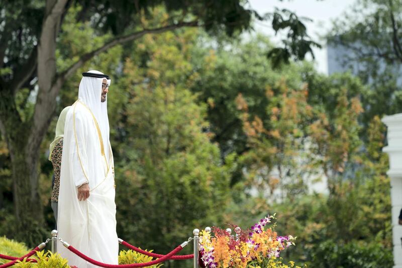SINGAPORE, SINGAPORE - February 28, 2019: HH Sheikh Mohamed bin Zayed Al Nahyan, Crown Prince of Abu Dhabi and Deputy Supreme Commander of the UAE Armed Forces (L) and HE Halimah Yacob, President of Singapore (back L - partially hidden), stand for the national anthem, during a reception at the Istana presidential palace.

( Eissa Al Hammadi for the Ministry of Presidential Affairs )
---