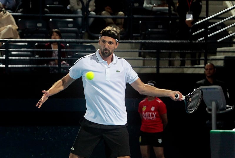 Dubai, United Arab Emirates - December 15, 2015.  Goran Ivanisevic ( Obi UAE Royals ) in action against Carlos Moya ( OUE Singapore Slammers ) at their ongoing Men's Legends Singles match for the International Premier Tennis League.  ( Jeffrey E Biteng / The National )  Editor's Note; ID 95301 *** Local Caption ***  JB151215-IPTL22.jpg