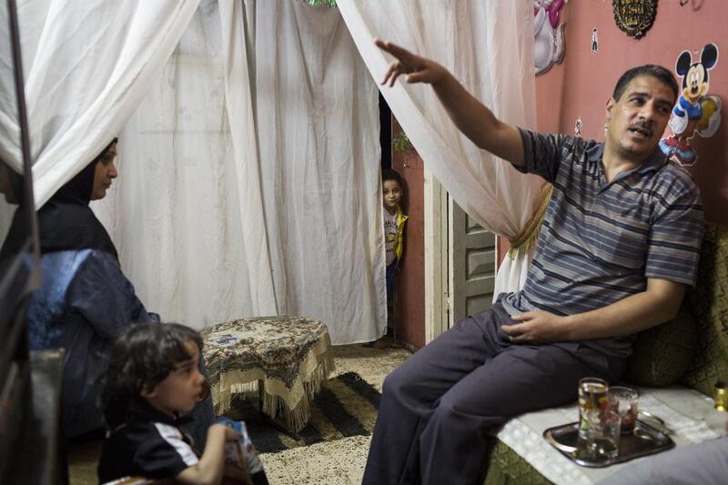 Said Nagib and his family gather in the living room of their tiny apartment in Cairo. Economically struggling Egypt is experiencing a serious housing crisis. David Degner / The National

