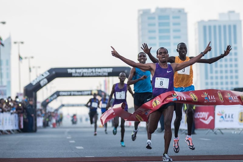 Birhanu Legese, centre, wins the RAK Half Marathon on Friday and was followed by Stanley Beyott, right, and Nguste Falidat. Natheer Halawani for The National 