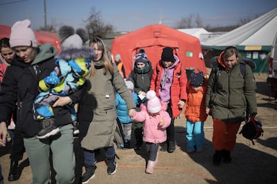 Refugees fleeing Ukraine are receiving aid from the International Red Cross and other charitable organisations at the Vysne Nemecke border. Getty Images