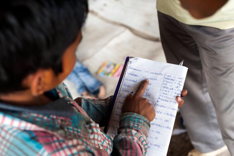 8th April 2013, Shakarpur, New Delhi, India. Veeresh Kumar (9) reads from his exercise book at the makeshift school under a metro bridge near the Yamuna Bank Metro station in Shakarpur, New Delhi, India on the 8th April 2013. He particularly likes Maths and English and he lives with his parents who are market gardeners in makeshift accommodation on the banks of the Yamuna River nearby.

Rajesh Kumar Sharma (40), started this makeshift school a year ago. Five days a week, he takes out two hours to teach when his younger brother replaces him at his general store in Shakarpur. His students are children of labourers, rickshaw-pullers and farm workers. This is the 3rd site he has used to teach under privileged children in the city, he began in 1997 fifteen years ago. 

PHOTOGRAPH BY AND COPYRIGHT OF SIMON DE TREY-WHITE

+ 91 98103 99809
+ 91 11 435 06980
+44 07966 405896
+44 1963 220 745
email: simon@simondetreywhite.com