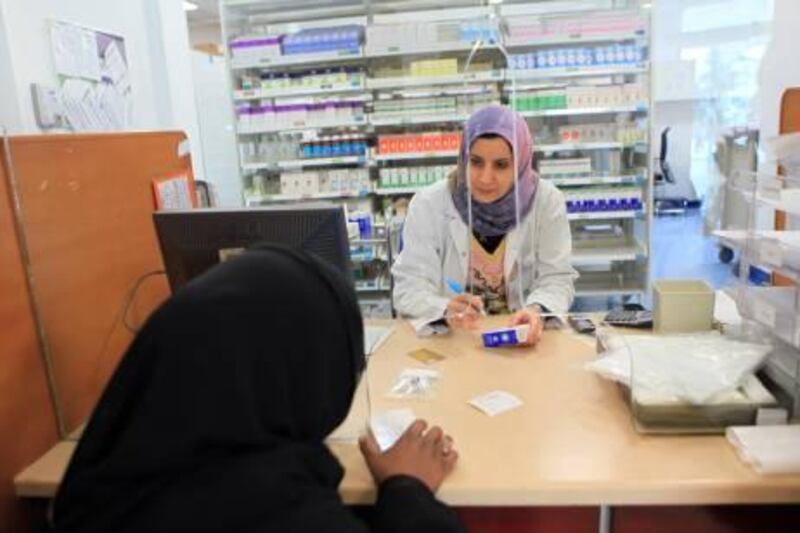 ABU DHABI - 04JAN2011- A patient collects her medicine from pharmacy at Baniyas Clinic in Abu Dhabi. Ravindranath K / The National