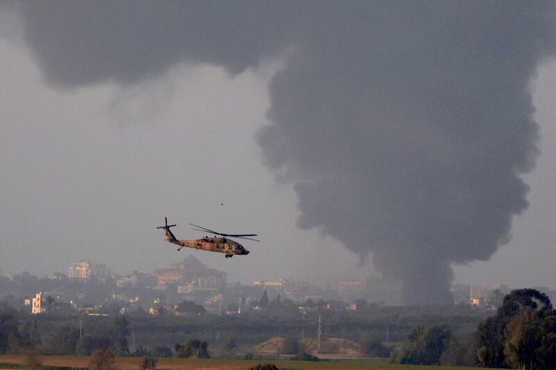 An Israeli army helicopter flies as smoke billows from the Gaza Strip. The war in the Palestinian enclave has had dire economic consequences. EPA